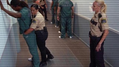 Voluptuous jail guard rides a hard inmate for a messy facial