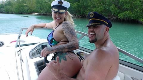 Tattooed MILF rides his big cock on a wild boat